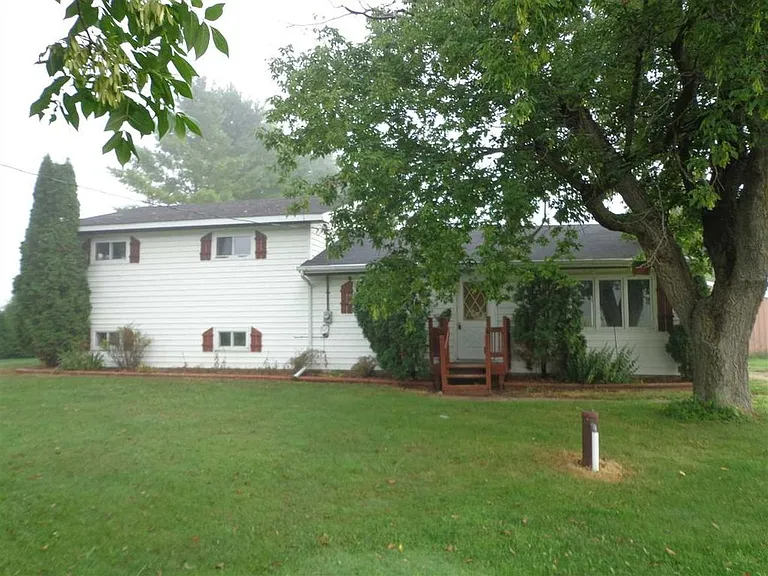 Spacious front lawn with beautiful trees and great landscaping potential.