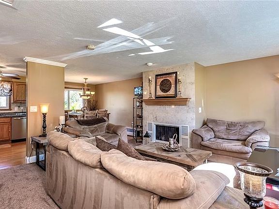 Family room features a wood burning fireplace with marble surround.