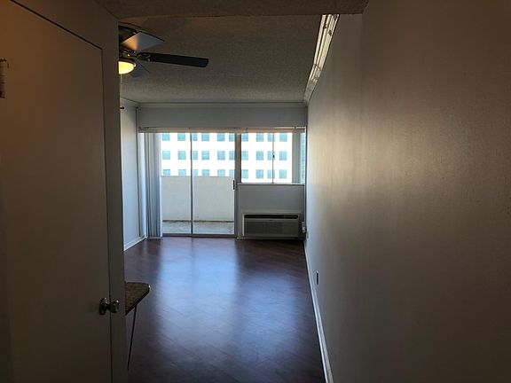 Living room--teak laminate wood flooring, individual heat and air control, walkout balcony, ceiling fan.
