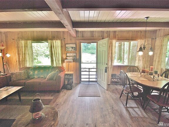 Entry, luxury vinyl floors, cedar lined walls, updated double pane windows, and open space for entertaining.