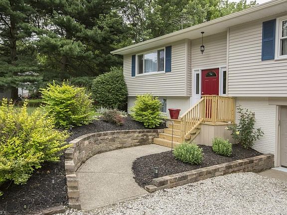 New retaining walls and landscaping, as well as new front porch! Siding and gutters are new also!