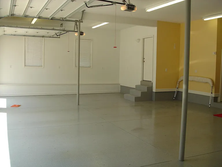 Fully finished and heated garage. Epoxy flooring and extensive lighting. Door to second floor loft space shown here.