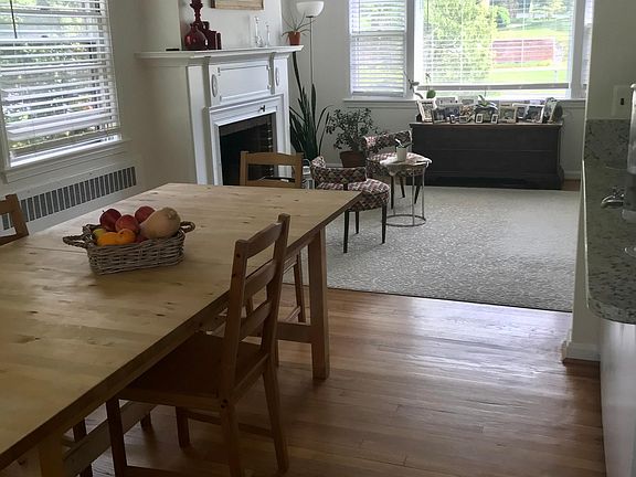 Open space Kitchen + Dining room +Living room all with hardwood floors. View from dining room.