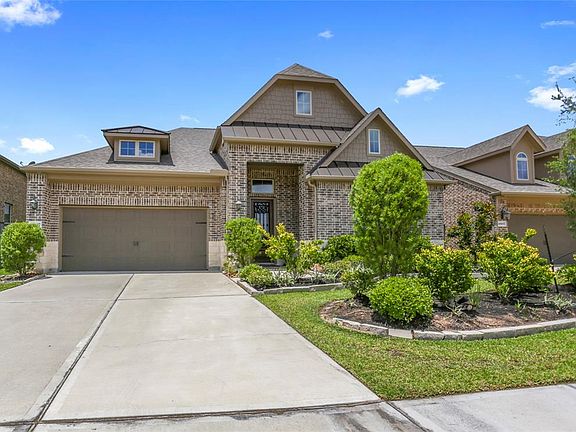 This luxury, low-maintenance patio home in the gated section of Wildwood shows like a model.