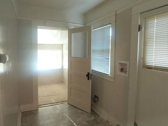 Washer and dryer hookups in this laundry area.
