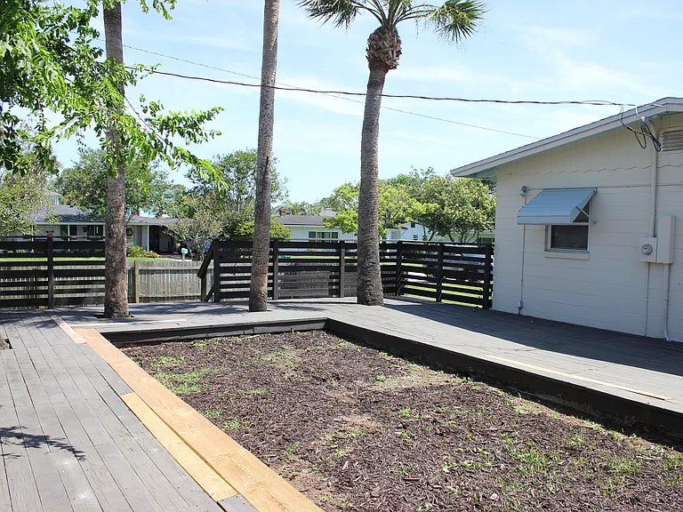 deck with palm trees and room for a grill