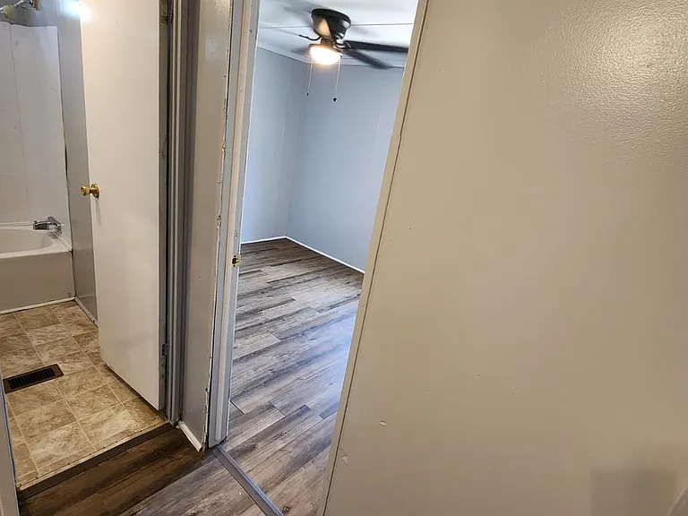 Hallway view to middle bathroom and bedrooms