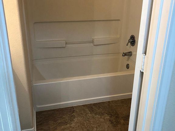 Secondary bathroom in between secondary bedrooms - sink is to left, toilet to right.