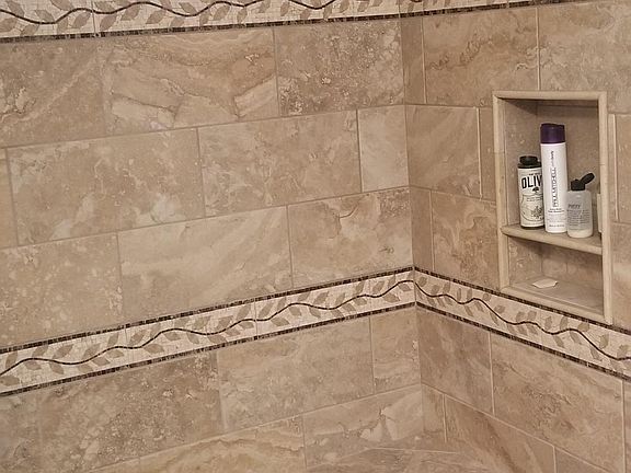 Zero edge entry to this custom made shower area. Kolher toilet, Moen faucet, as-new semi-custom cabinet.