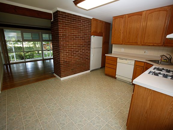 Kitchen with view of living room, hardwood floors and back,