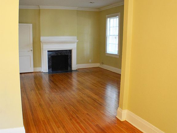 Beautiful Hardwood Floors and arched doorways.