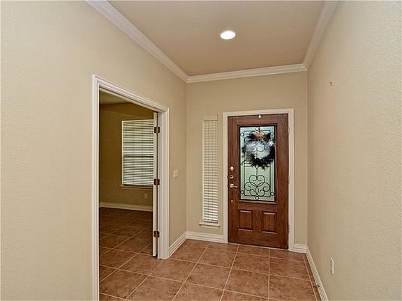 Inviting entry with french doors leading to office.