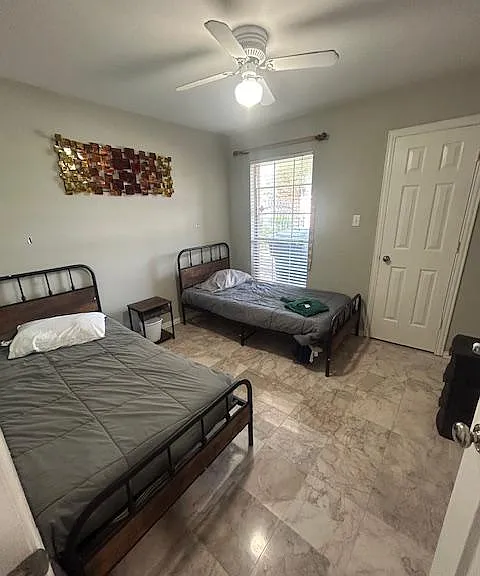 Spacious private room with desk spaceideal for remote work. Beds can be combined. Shared full bathroom nearby.