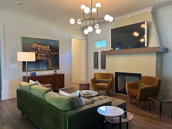 Modern living room with fireplace in a great room format.