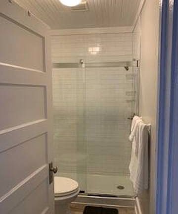 Updated bathroom. Walk-in shower w/ floor to ceiling tile surround.