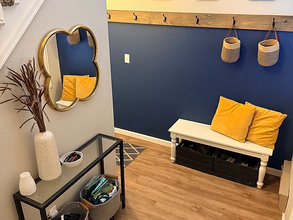 Entry with updated flooring and coat rack