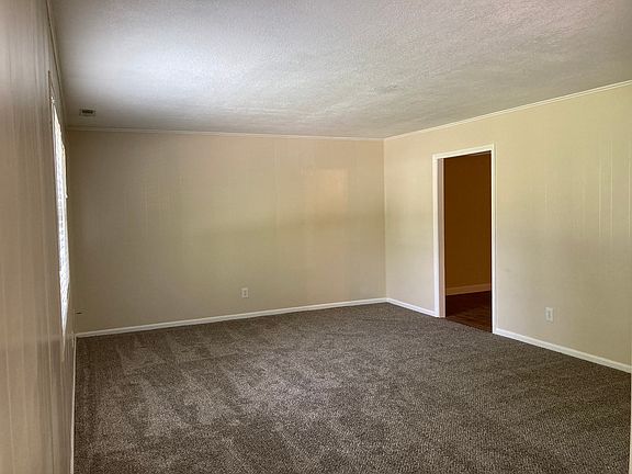 View of living room from front door to dining area door.