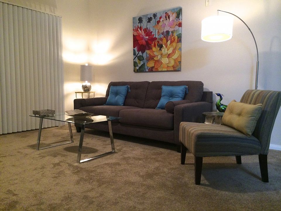 comfortable seating area, ceiling fan, entry to patio