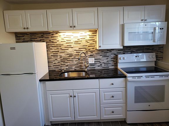 New Stove, Microwave Hood, granite, backsplash, and tile floor.