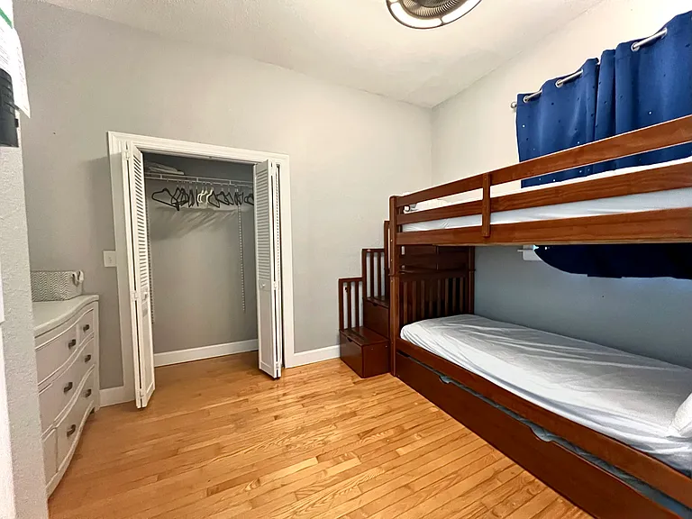 Larger of upper floor bedrooms with bunkbed + trundle bed.