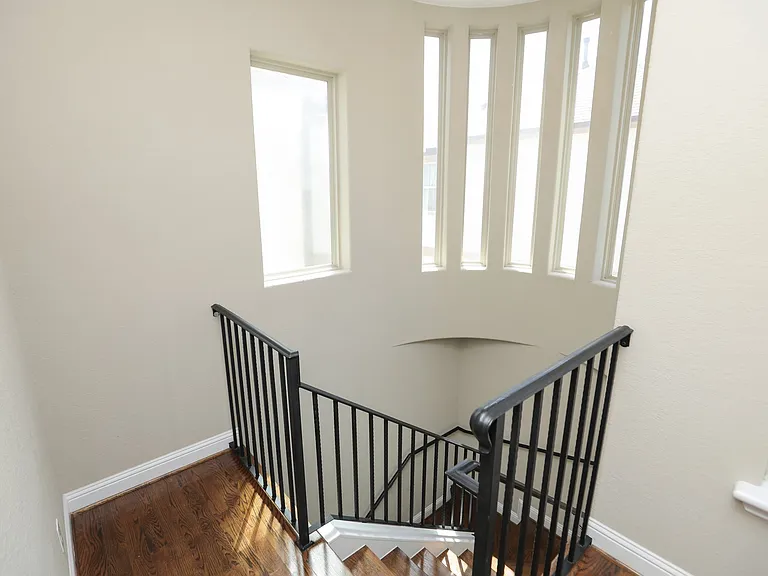 Beautiful spiral stairs leading to 3rd floor with beautiful natural light.