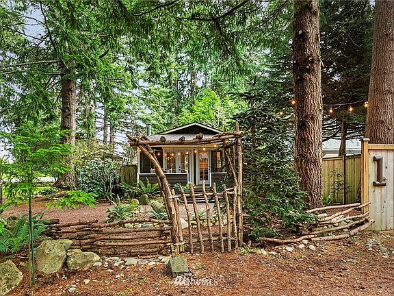This charming gate invites you into the property! Note the "1" house number on the fence!