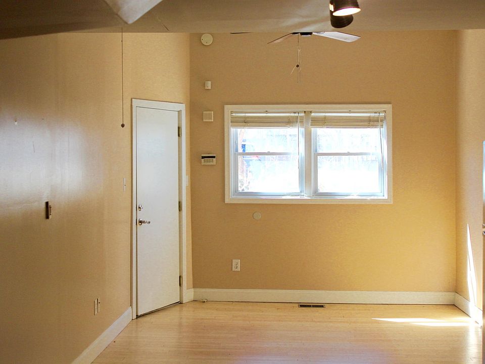 This is the living room. That is the front door on the left. There is a ceiling fan. I'm standing in the kitchen area while taking this pic.
