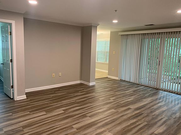Living area with sliding door and recessed lighting.