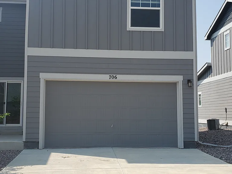 2 car garage and driveway at rear