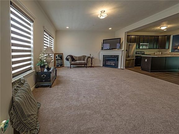 The bright encased windows in the neutral family room flood the home with sunlight.  The first level boasts 9' ceilings and a fu