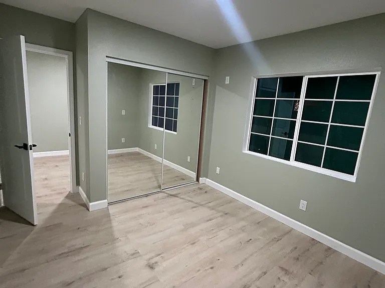 Bright bedroom with large closet and natural light.