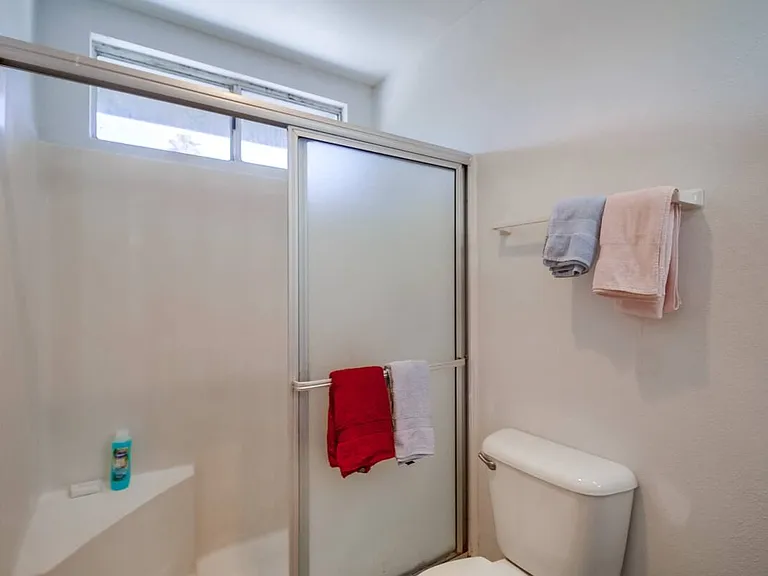 Refresh in the fully stocked bathroom with soap, shampoo, and a hairdryer.