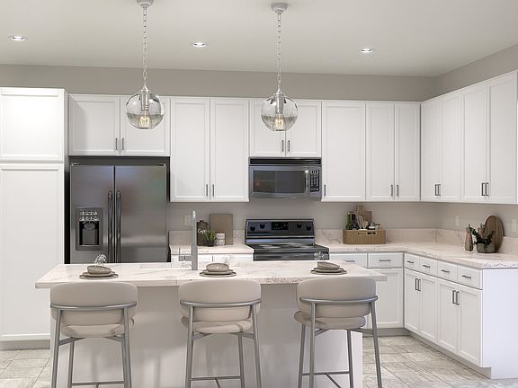 The Kitchen features stainless steel appliances and large Kitchen Island with seating for casual din