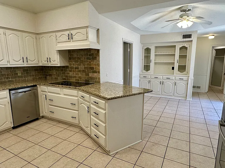 Dining area with baseboards, ceiling fan, and light tile patterned floors