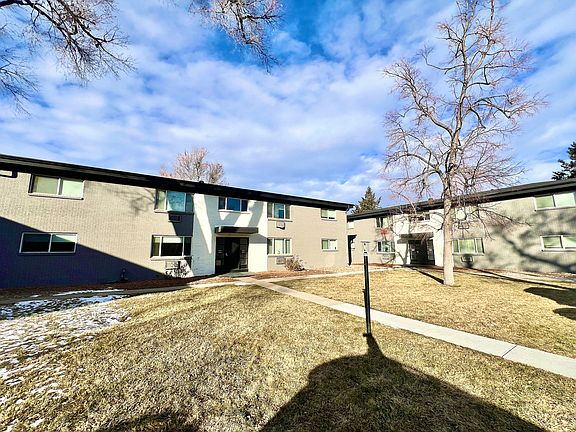 Explore the inviting exterior of this modern apartment complex, where natural light and open spaces create a harmonious living environment.