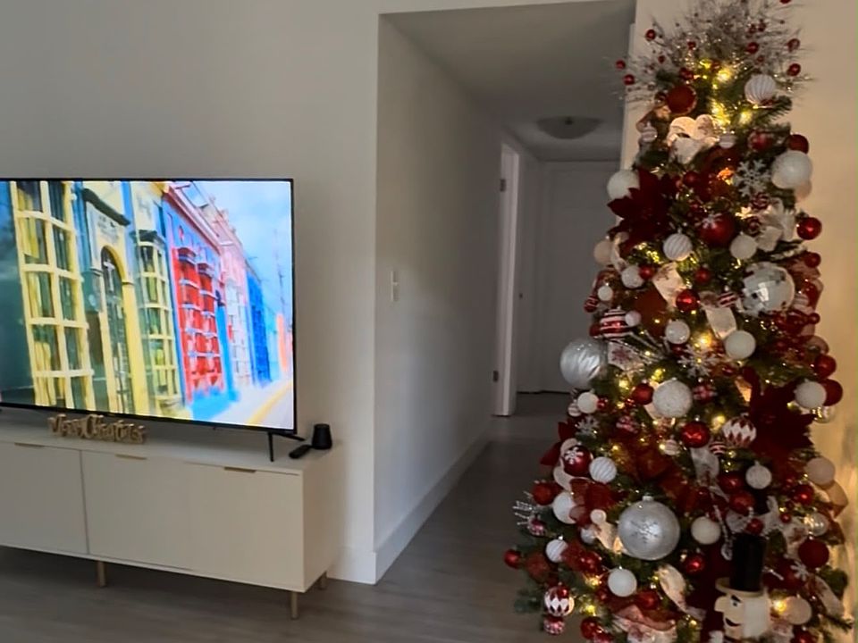 Bright and inviting living room featuring attractive wood-look flooring, neutral finishes, and ample space for comfortable seating and entertainment.