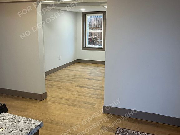 In kitchen standing at Entry door of apartment.