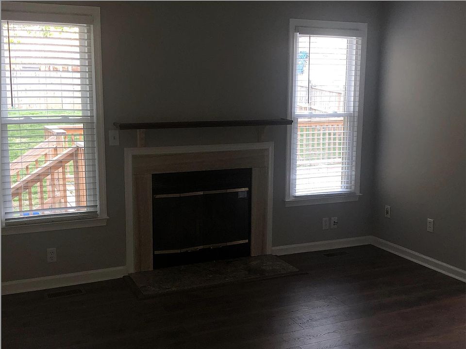 Family room with cozy fireplace overlooking the oversized deck and fenced-in back yard.