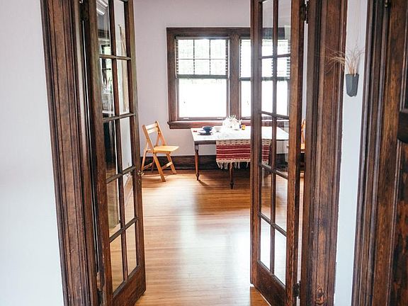 French doors off living room, view into dining room.