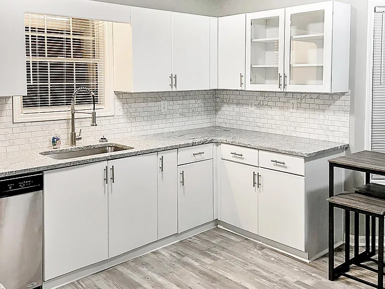 kitchen stocked with cleaning supplies and drinking glasses