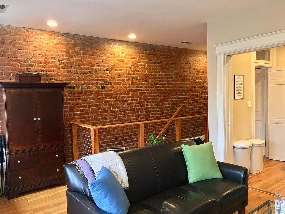Original brick wall running the length of the apartment