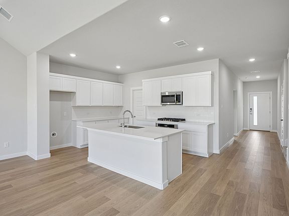 Kitchen in the Masters home plan by Trophy Signature Homes - REPRESENTATIVE PHOTO