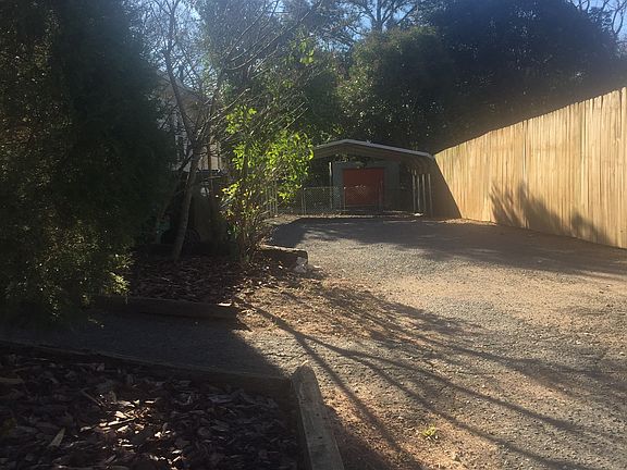 long gravel drive w/ carport