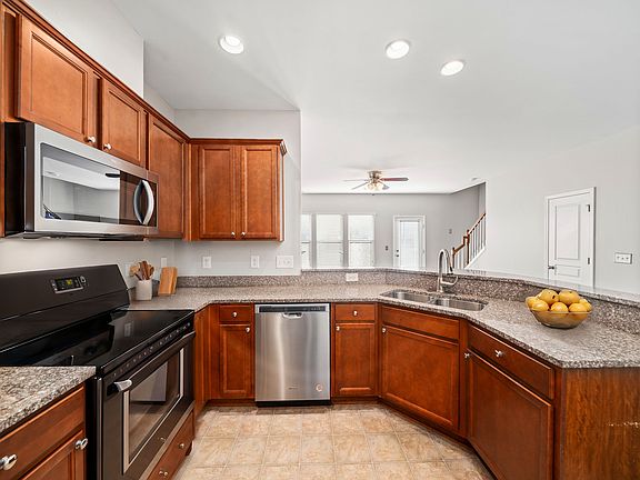Beautiful kitchen with stainless steel appliances, pantry, and granite countertops