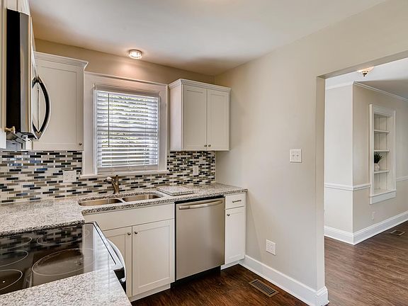 This small kitchen even has a window above the sink, dishwasher and built in microwave.
