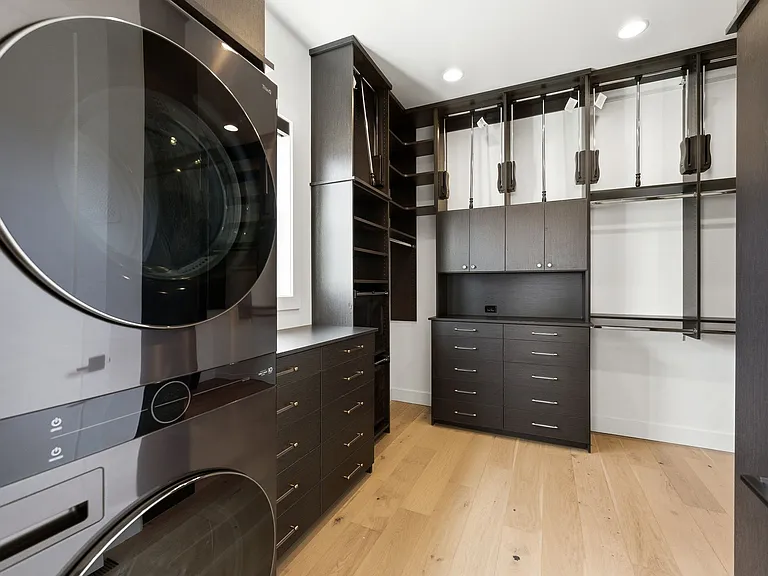 Incredible walk in custom closet. Stackable laundry