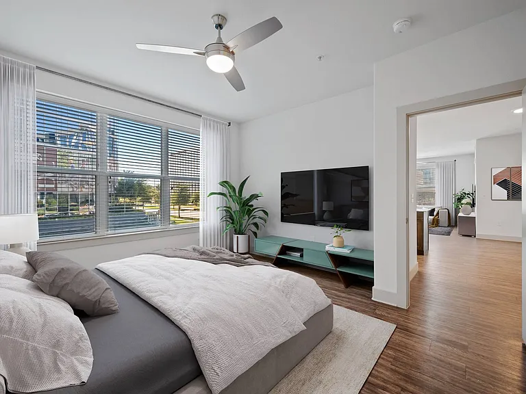 Light-filled bedroom with wood-style flooring and beautiful views
