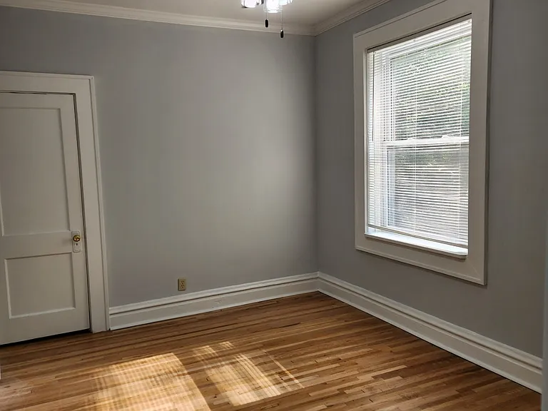 Bedroom with newly refinished original hardwood.
