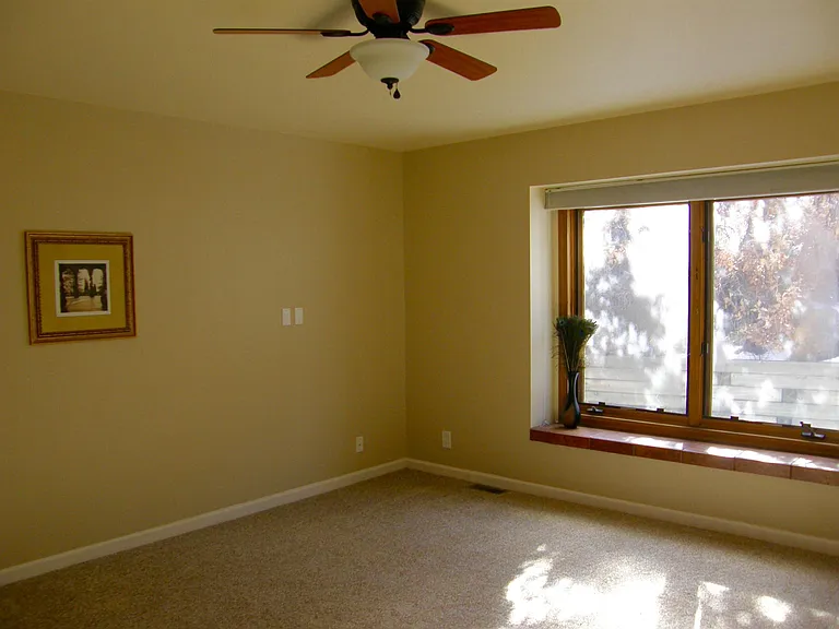 Master bedroom with large windows to backyard