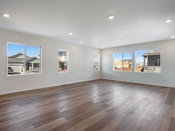 Great room filled with natural light and the shine of wood vinyl flooring